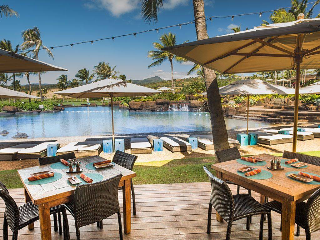11 Lot Koloa, HI 96756 - Photo 6 of 9 a view of a patio with table and chairs under an umbrella
