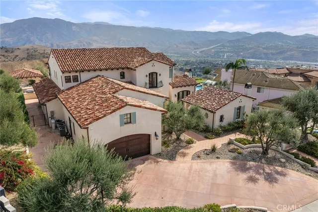 a view of a house with a mountain in the background