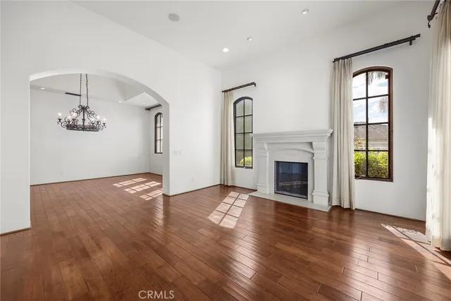 a view of a livingroom with wooden floor and windows