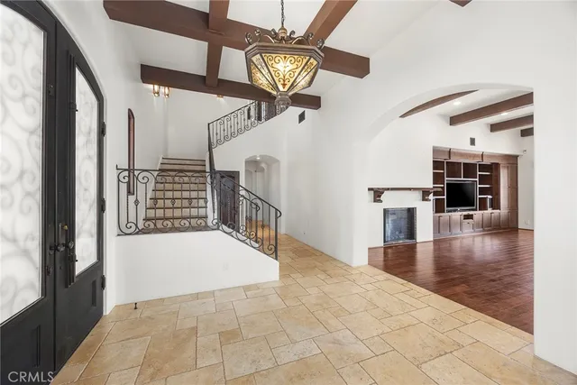 an empty room with wooden floor and a floor to ceiling window