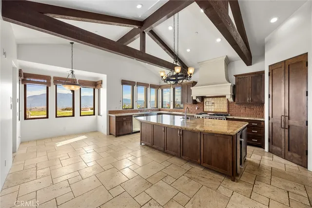 a large kitchen with a large counter top and stainless steel appliances