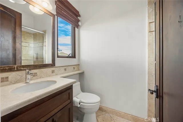 a bathroom with a sink mirror toilet and bathtub