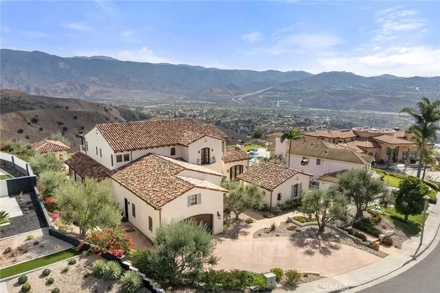 an aerial view of a house with a mountain view