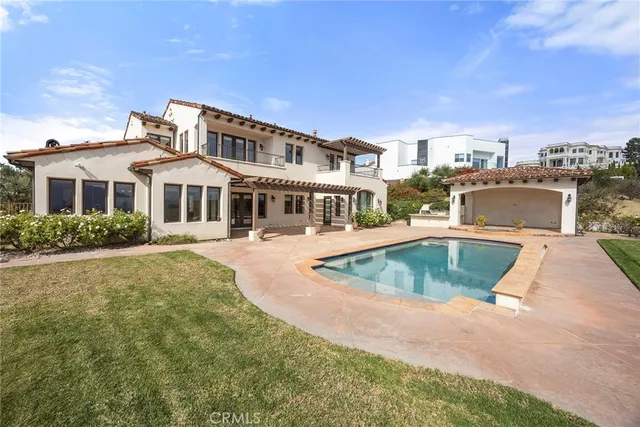a view of a house with swimming pool and sitting area