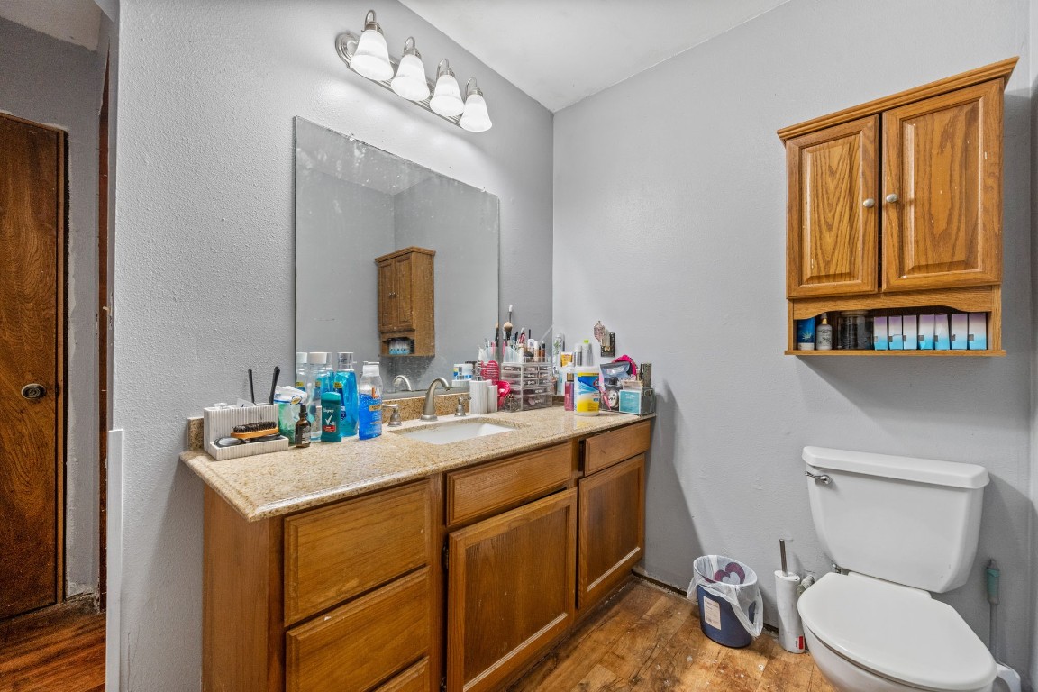 71 Shady Oaks Point Blank, TX 77364 - Photo 15 of 32 a bathroom with a toilet sink and mirror