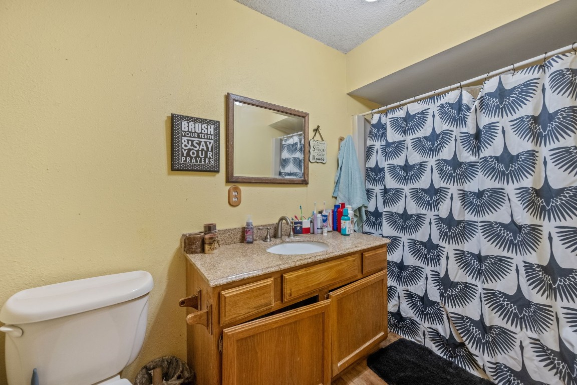 71 Shady Oaks Point Blank, TX 77364 - Photo 18 of 32 a bathroom with a sink toilet and a shower