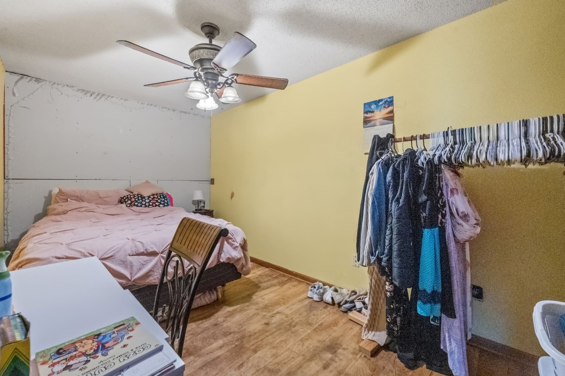 71 Shady Oaks Point Blank, TX 77364 - Photo 19 of 32 a bedroom with a bed and a chandelier