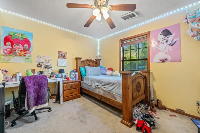 a bed room with a bed and a chandelier