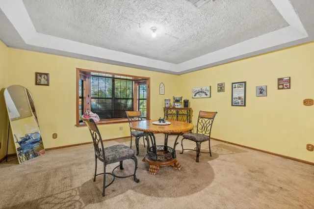 a dining room with furniture and a window