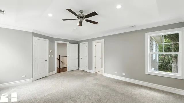 a view of a livingroom with a ceiling fan and window