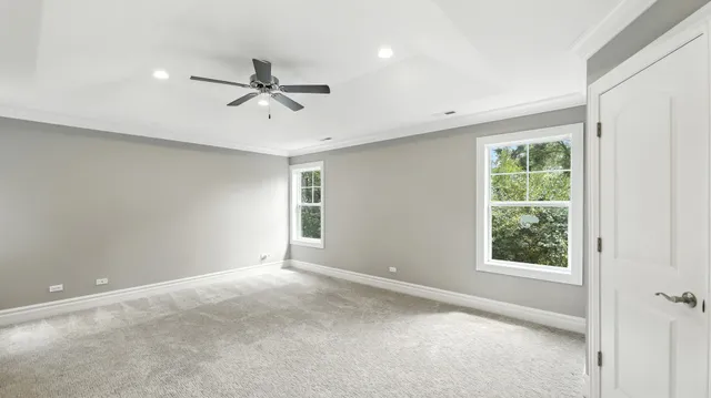 a spacious bathroom with a double vanity sink a mirror and a bathtub