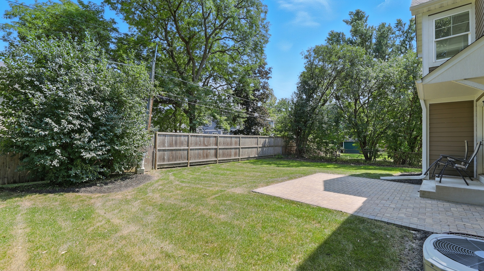 1127 Kenton Road Deerfield, IL 60015 - Photo 31 of 35 a view of a backyard with couches plants and large trees