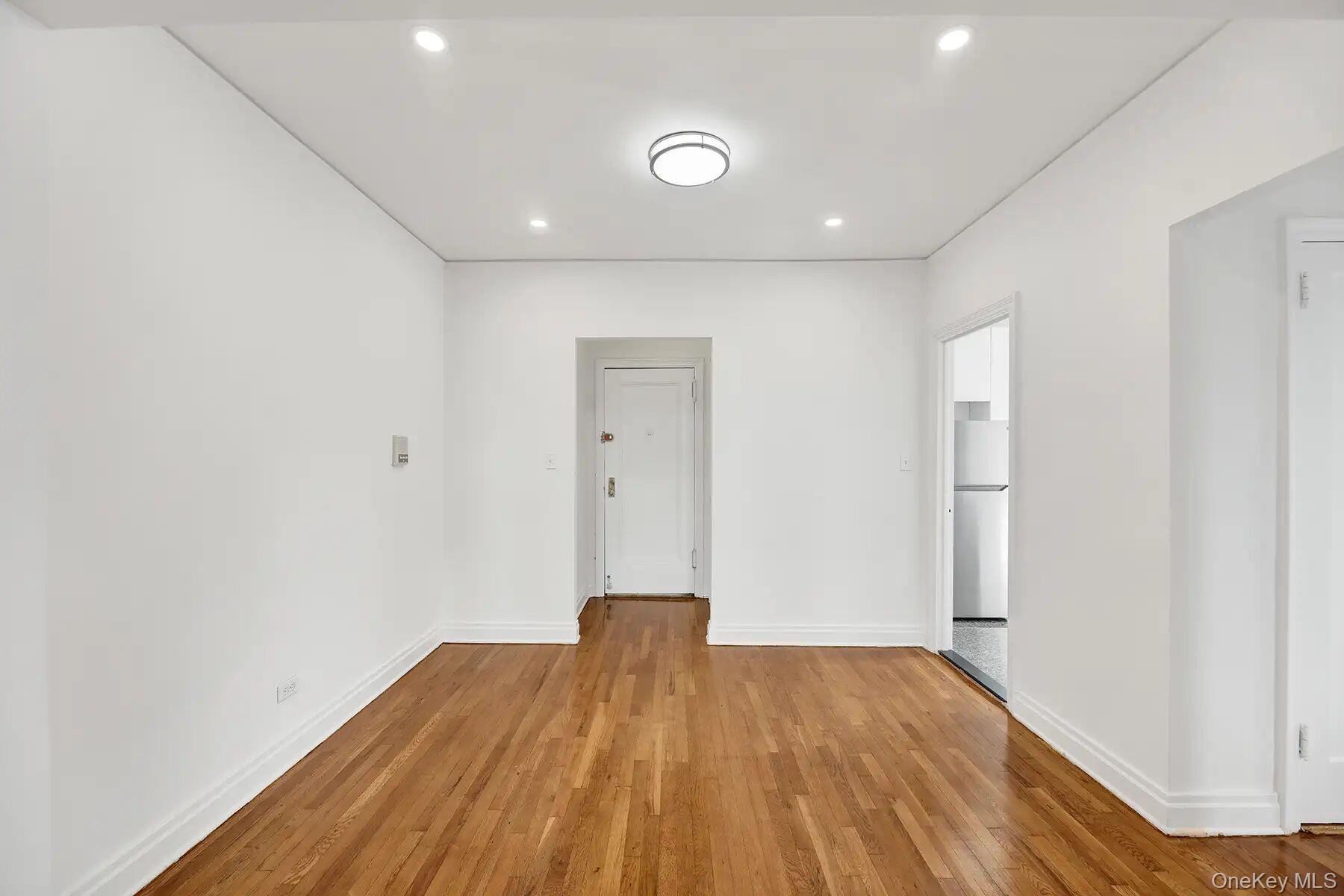 1 Ash Place, Unit 3A Great Neck, NY 11021 - Photo 3 of 10 Hardwood flooring throughout, recessed lighting, and a contemporary ceiling fixture