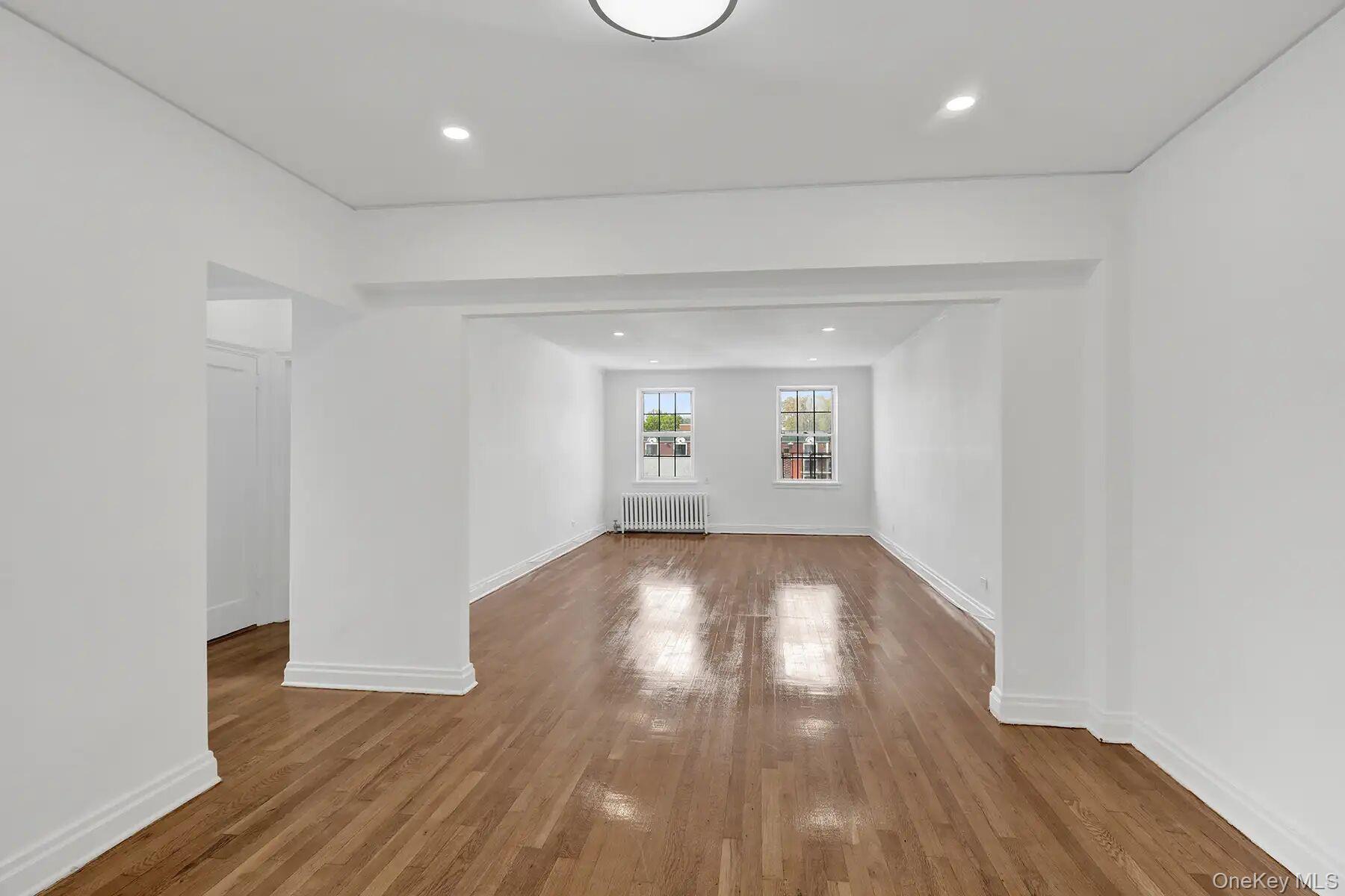 1 Ash Place, Unit 3A Great Neck, NY 11021 - Photo 4 of 10 Spacious interior featuring wood-finish flooring, white painted walls, recessed lighting, and a white baseboard trim