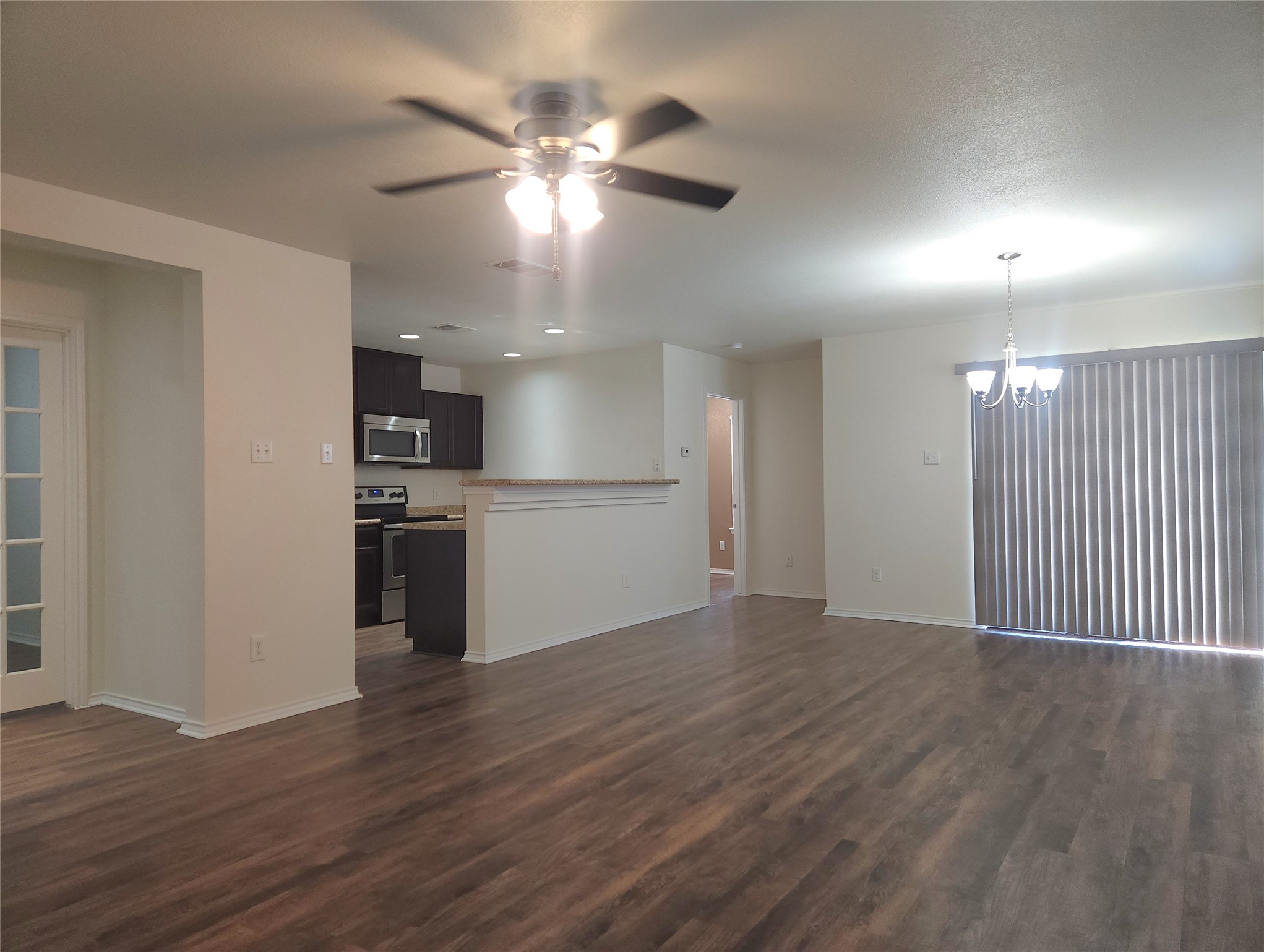 160 Rummel Drive Kyle, TX 78640 - Photo 3 of 13 An open-concept living space with sleek flooring creates a welcoming flow into the adjacent kitchen and dining area.