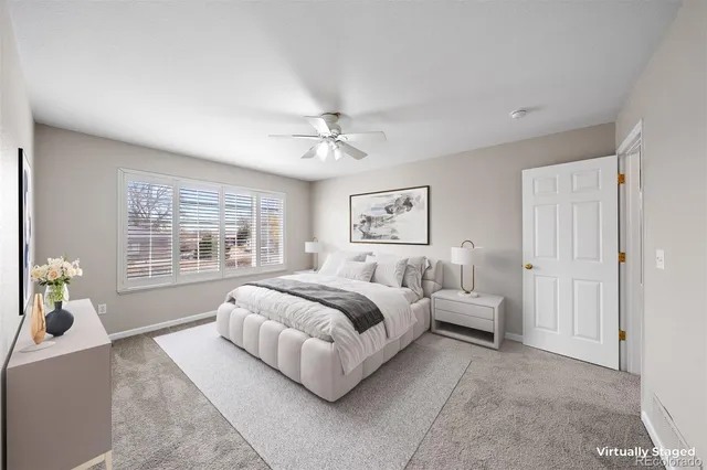 a spacious bedroom with a bed a couch and a window