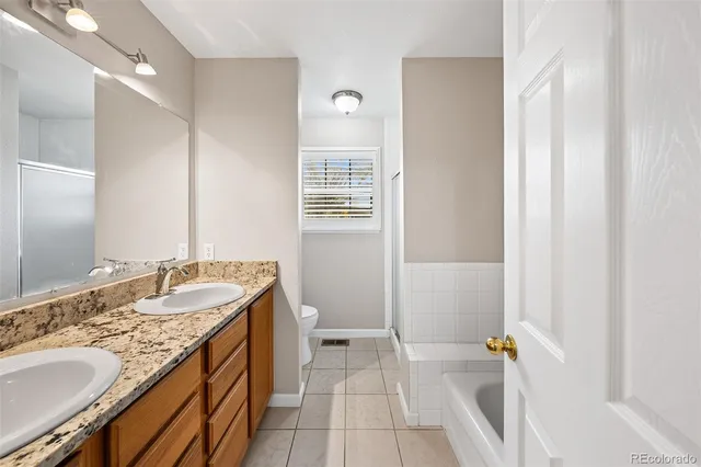 a spacious bathroom with a granite countertop sink and a mirror