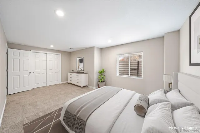 a spacious bedroom with a bed and a window