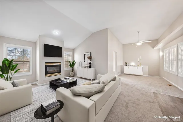a living room with furniture a fireplace and a flat screen tv