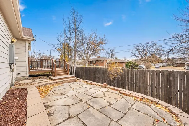 a view of backyard with wooden fence
