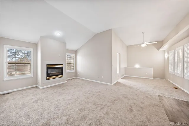 an empty room with a fireplace and a window