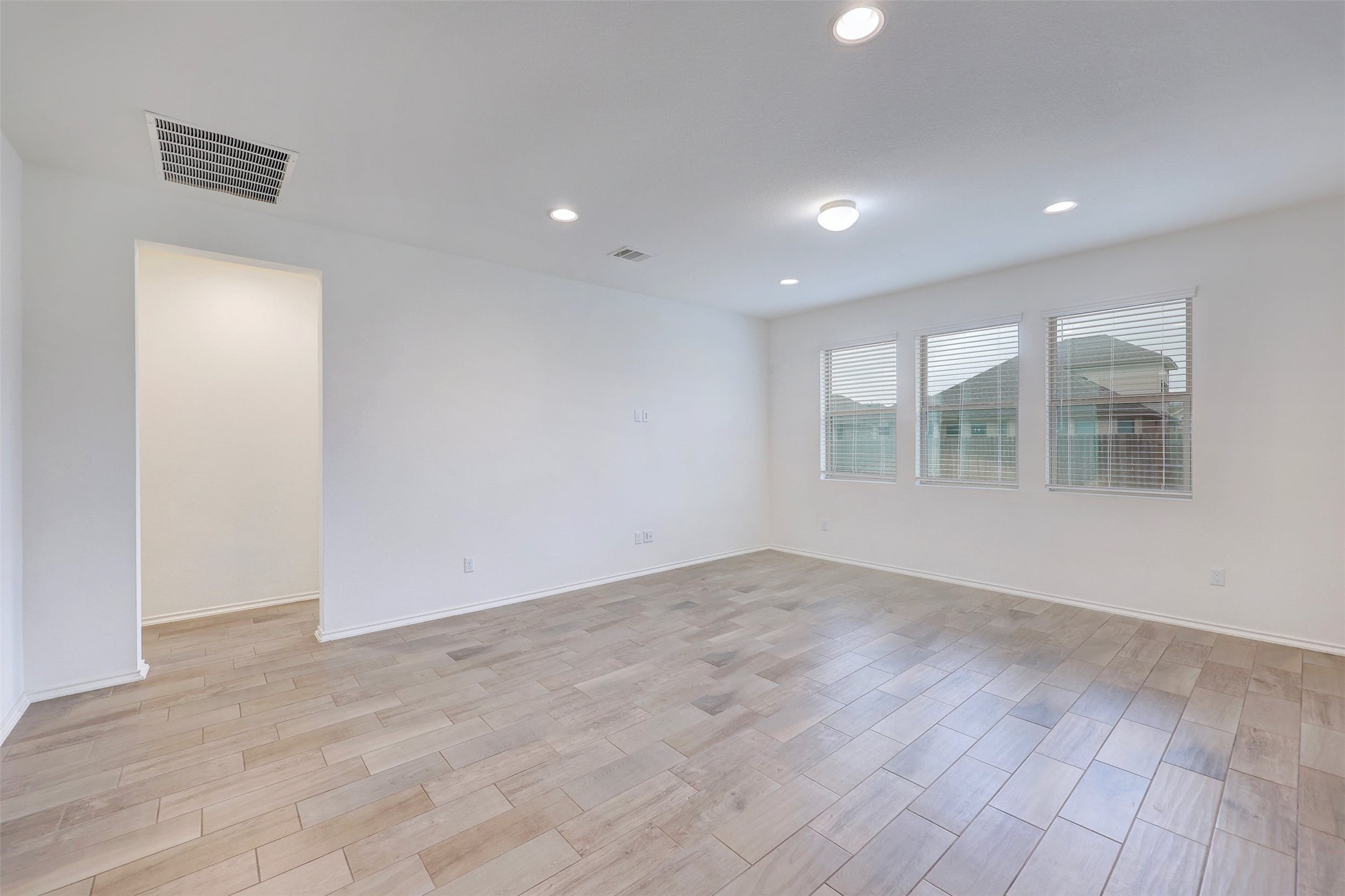307 Simmental Loop Hutto, TX 78634 - Photo 8 of 34 Recessed lighting illuminates this versatile room with durable tile flooring and natural light from multiple windows.