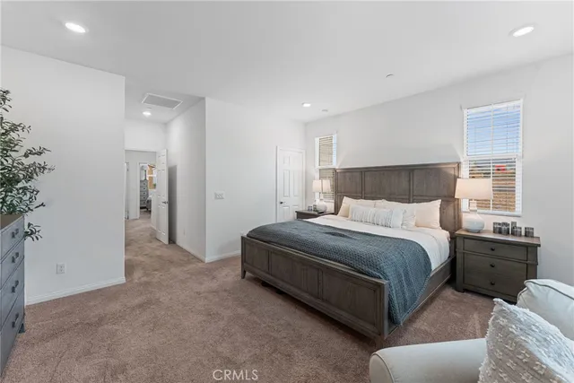 a spacious bedroom with a bed and a couch