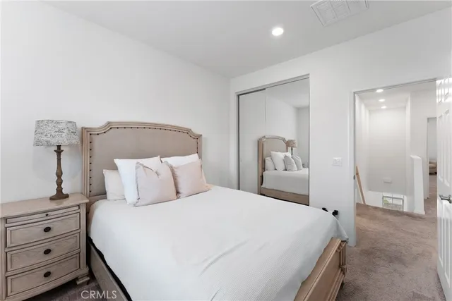 a bedroom with a bed and a mirror