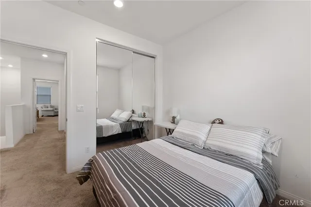 a bedroom with a bed and a couch