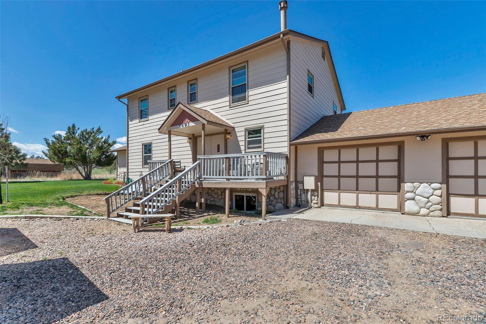 1493 Flintwood Road Franktown, CO 80116 - Photo 12 of 31 a front view of a house with garden