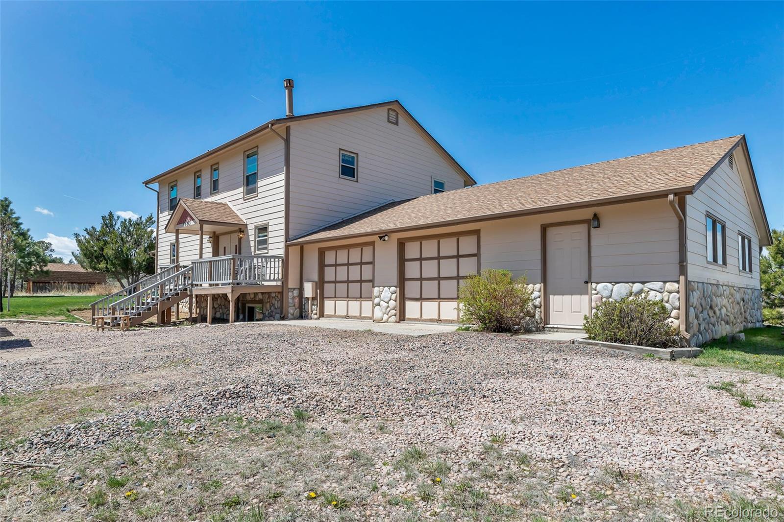 1493 Flintwood Road Franktown, CO 80116 - Photo 13 of 31 a view of a house with backyard and porch