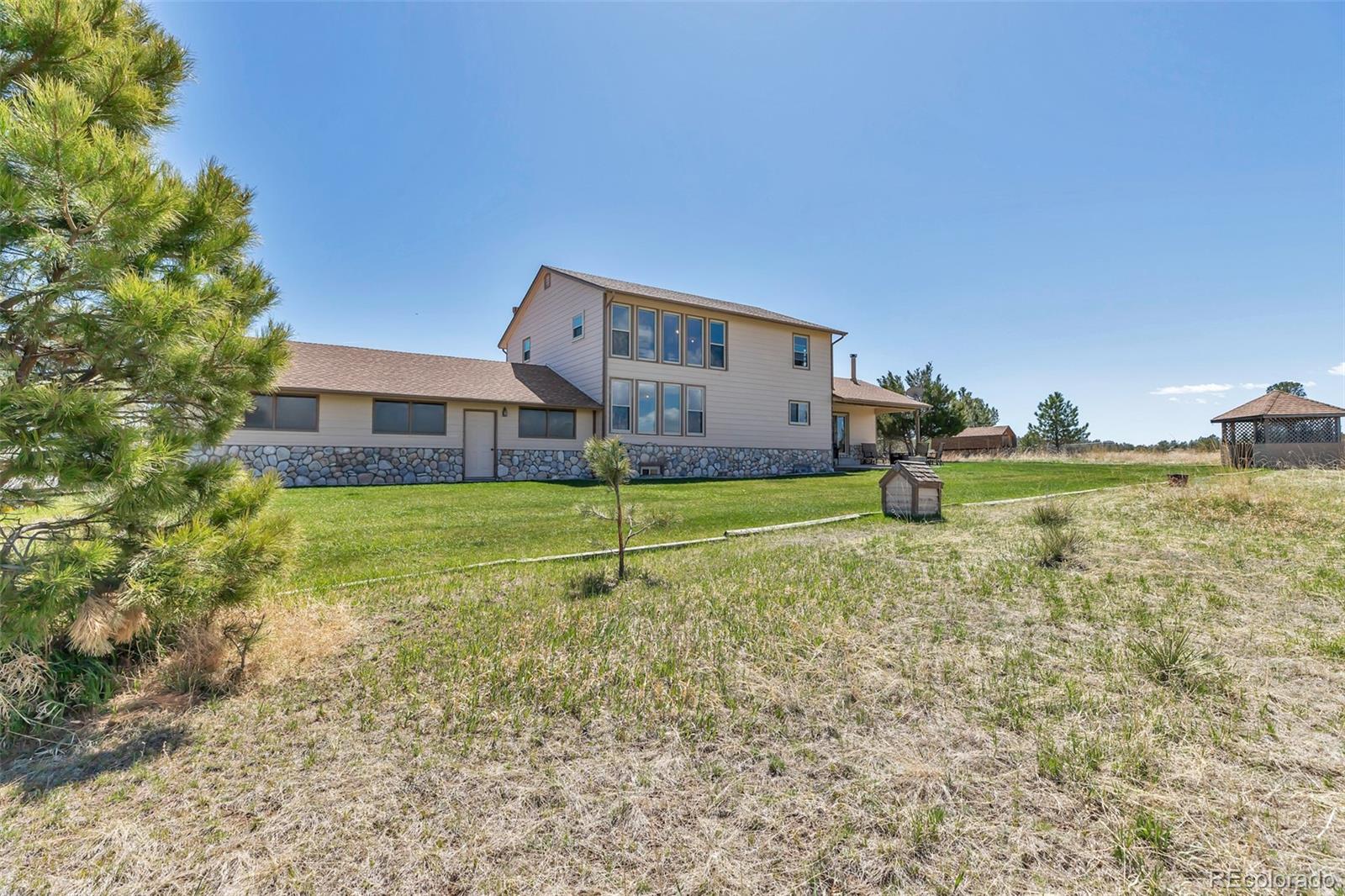 1493 Flintwood Road Franktown, CO 80116 - Photo 19 of 31 a house view with a outdoor space