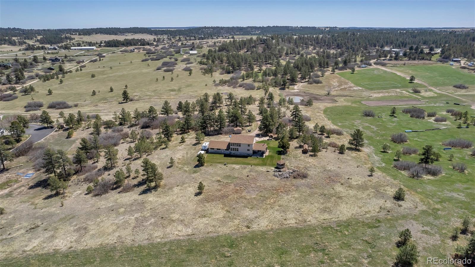 1493 Flintwood Road Franktown, CO 80116 - Photo 2 of 31 a view of a lake with beach and city view