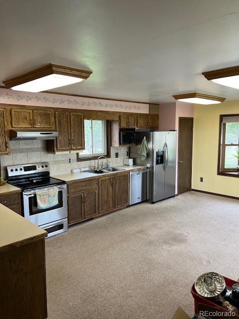 1493 Flintwood Road Franktown, CO 80116 - Photo 22 of 31 a kitchen with stainless steel appliances kitchen island a stove a sink dishwasher and a oven