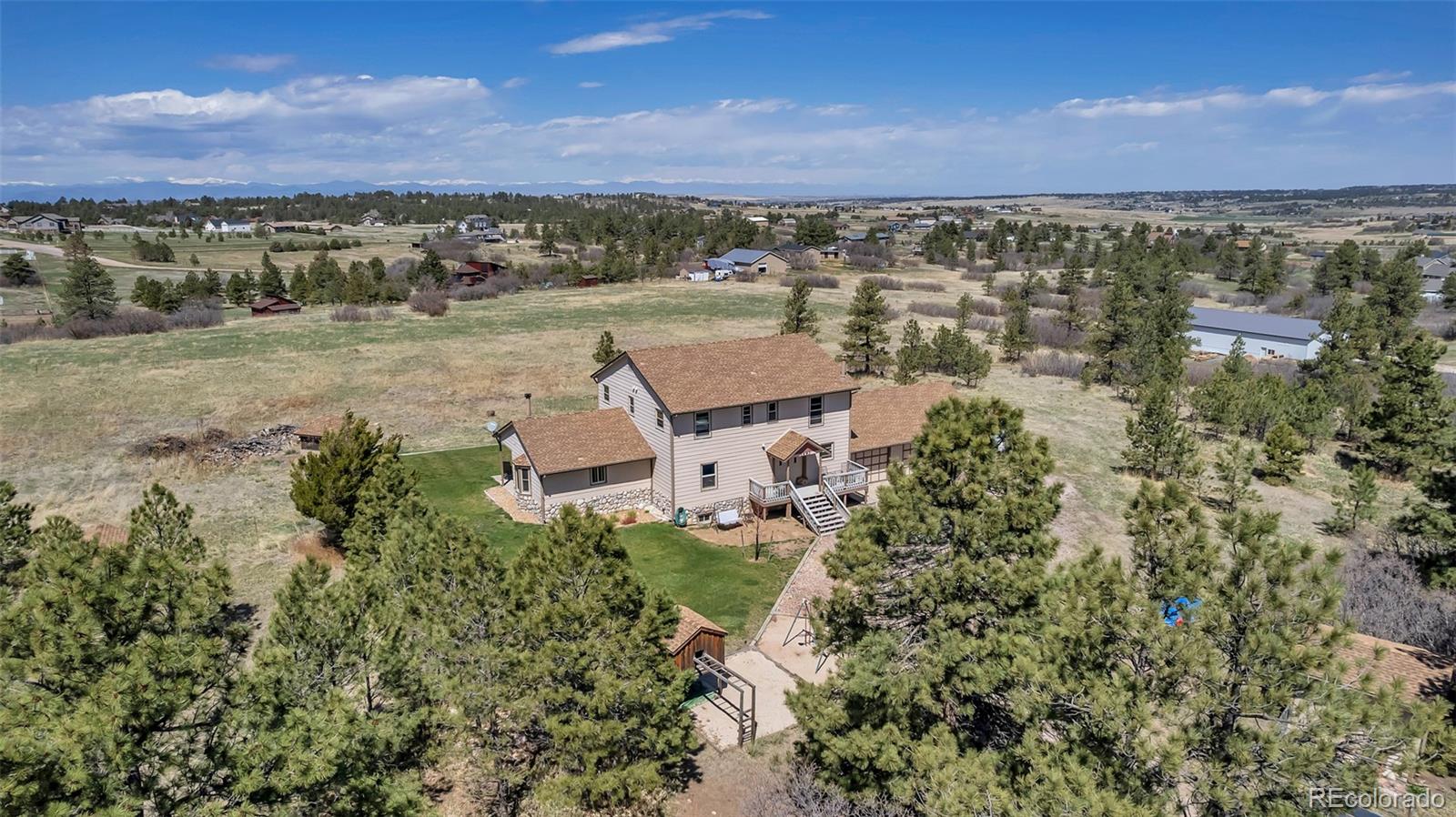 1493 Flintwood Road Franktown, CO 80116 - Photo 6 of 31 an aerial view of a house with a yard and lake view