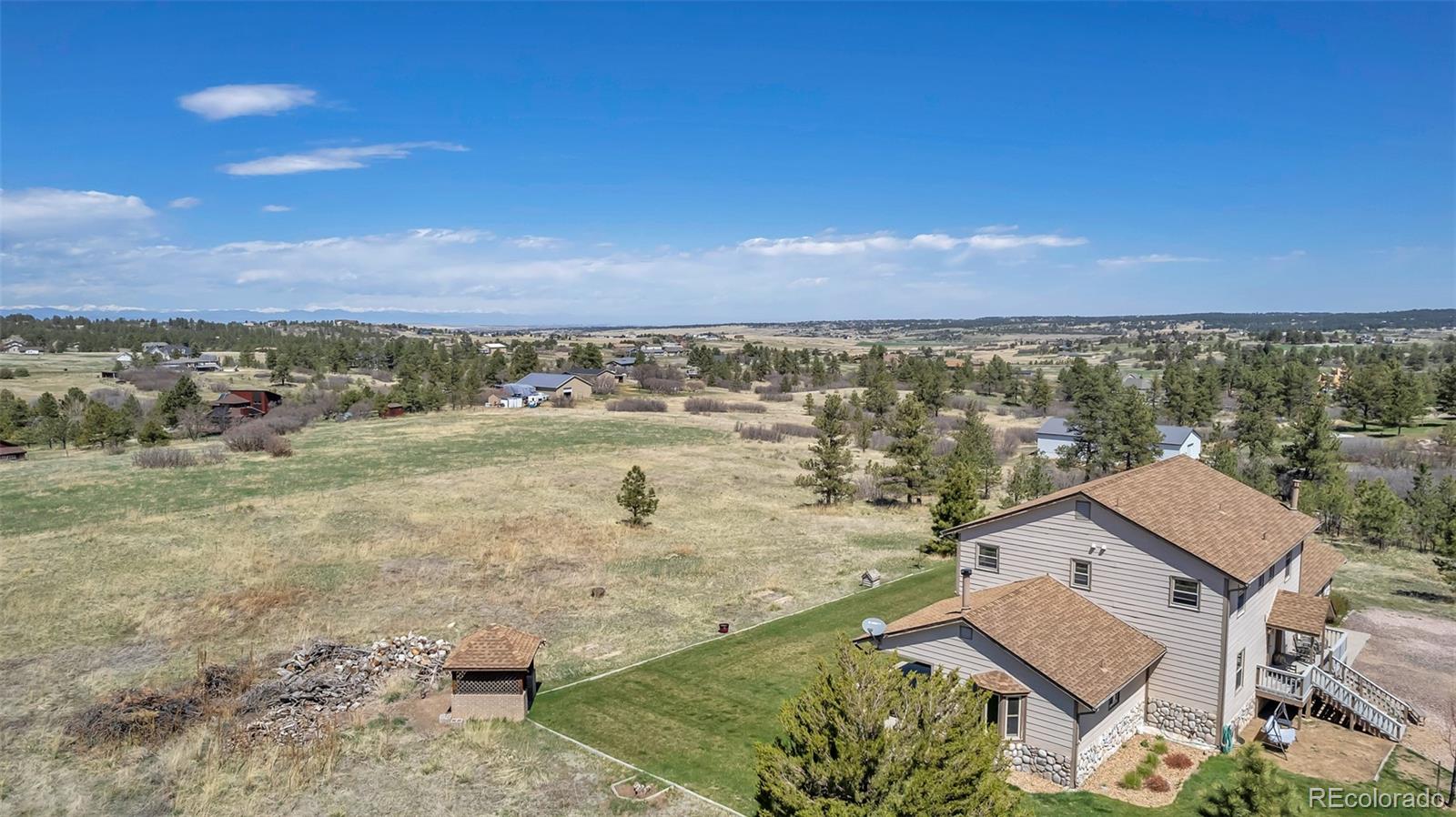 1493 Flintwood Road Franktown, CO 80116 - Photo 7 of 31 an aerial view of residential houses with outdoor space and trees