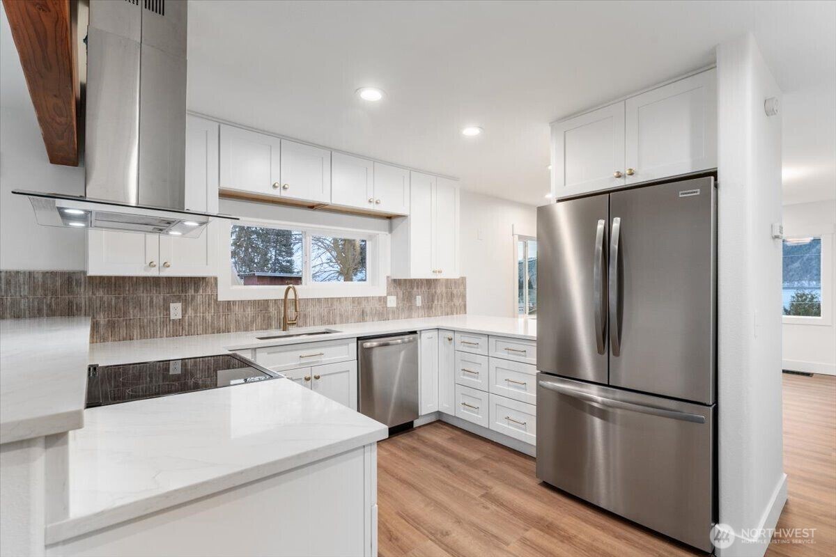 124 Boetzke Avenue Manson, WA 98831 - Photo 11 of 36 a kitchen with a refrigerator sink and cabinets