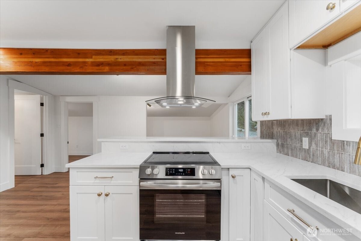124 Boetzke Avenue Manson, WA 98831 - Photo 12 of 36 a kitchen with stainless steel appliances granite countertop a stove and a sink