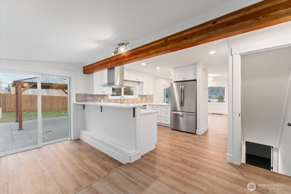124 Boetzke Avenue Manson, WA 98831 - Photo 13 of 36 a kitchen with stainless steel appliances a refrigerator and a stove top oven