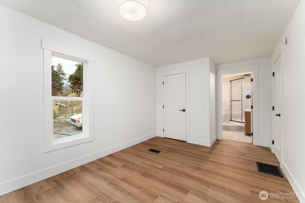 124 Boetzke Avenue Manson, WA 98831 - Photo 17 of 36 a view of a room with wooden floor and window