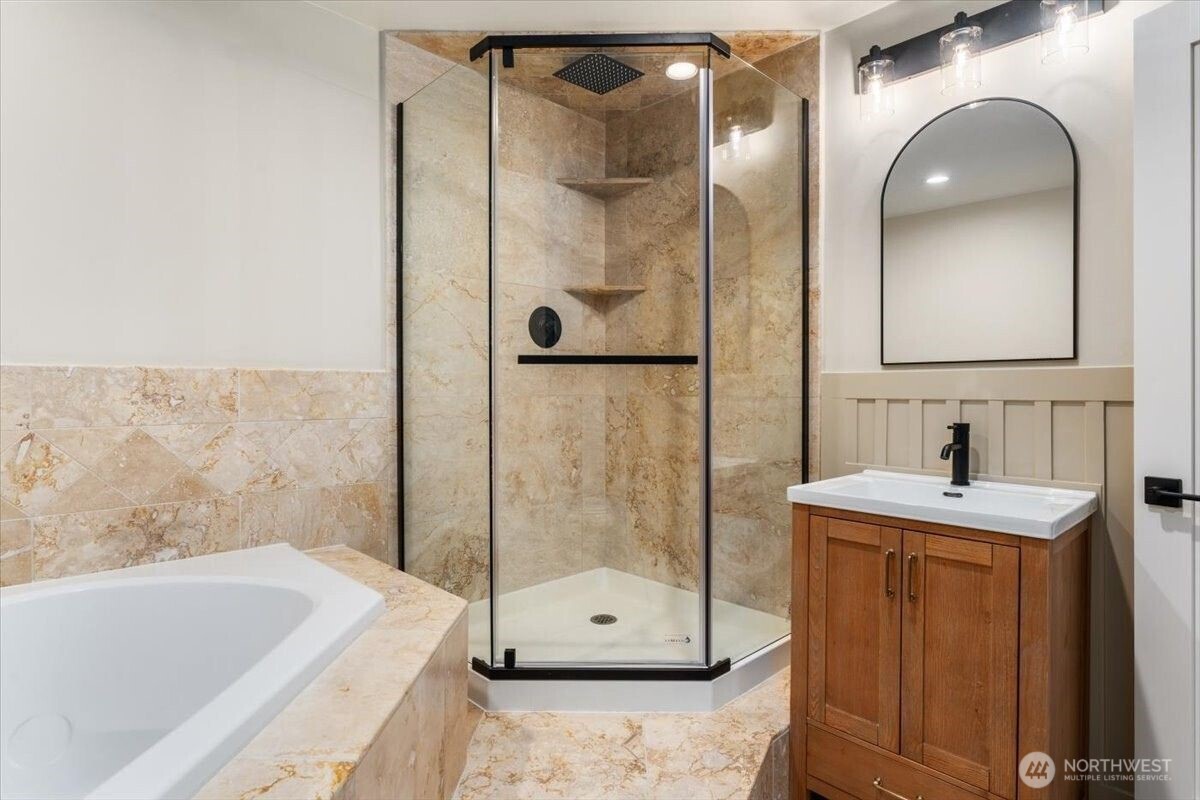 124 Boetzke Avenue Manson, WA 98831 - Photo 19 of 36 a bathroom with a tub a sink and mirrors