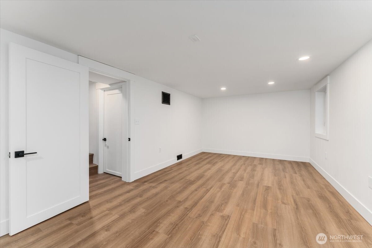 124 Boetzke Avenue Manson, WA 98831 - Photo 27 of 36 wooden floor in an empty room with a window