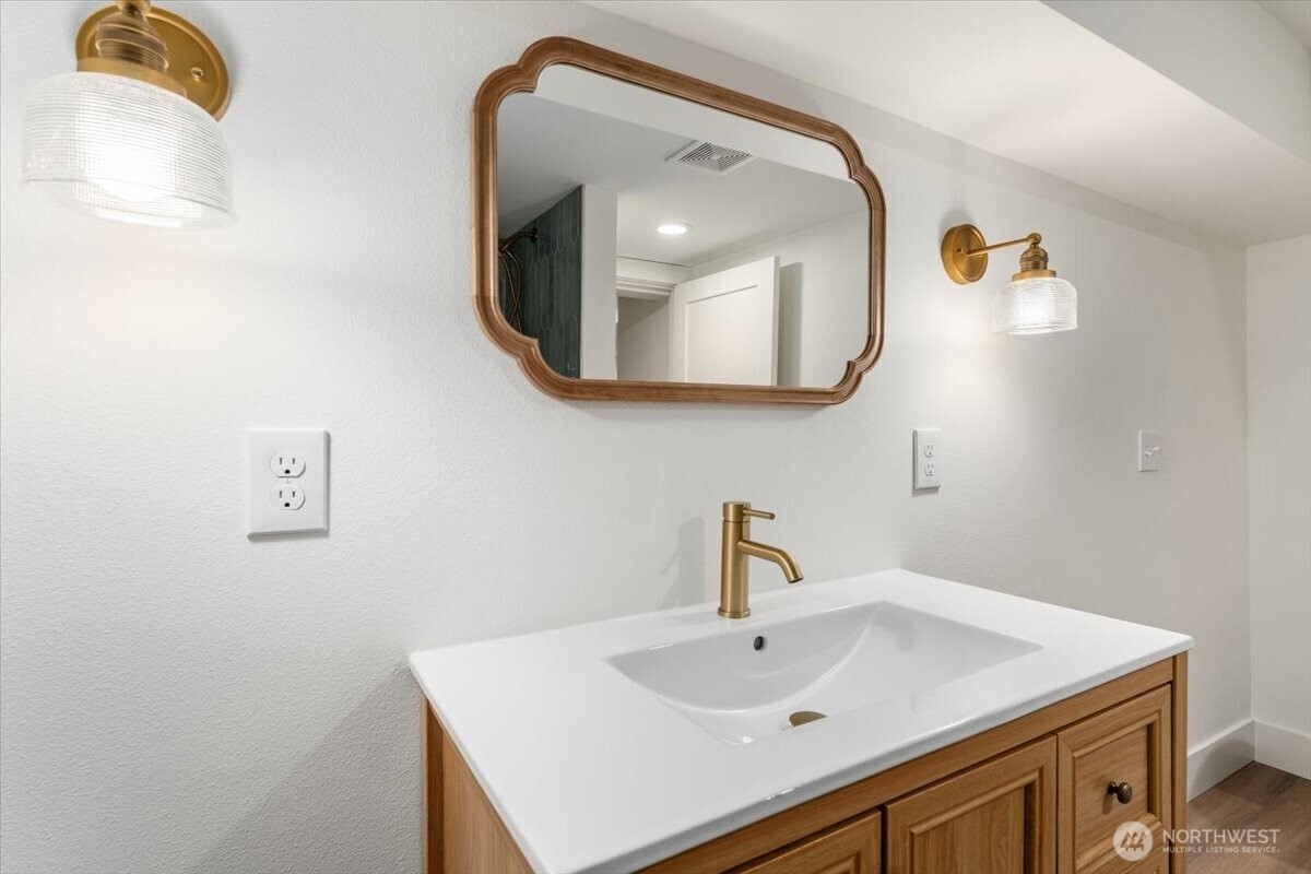 124 Boetzke Avenue Manson, WA 98831 - Photo 29 of 36 a bathroom with a sink vanity and a mirror