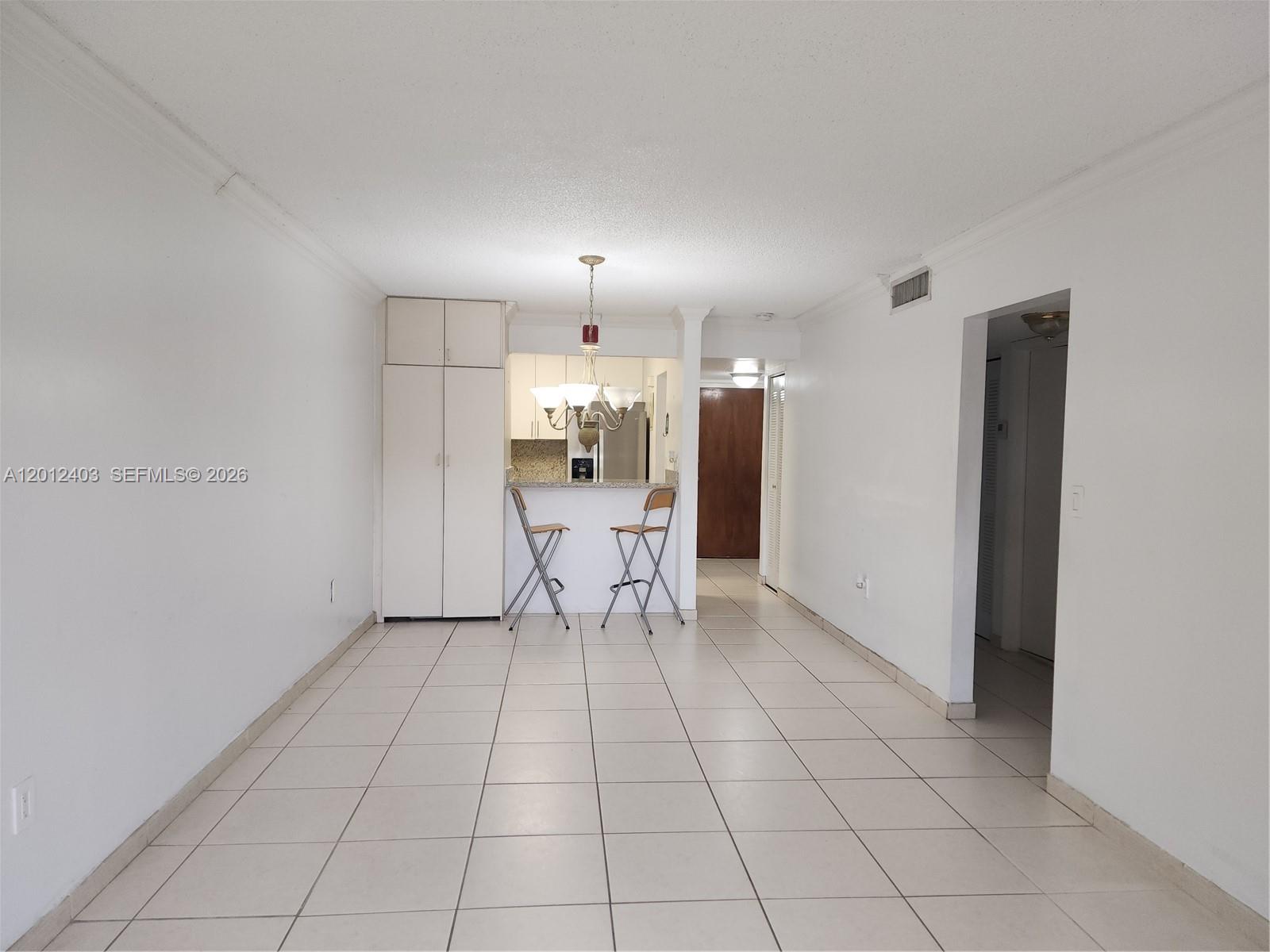 8990 Southwest 24th Street, Unit 19 Miami, FL 33165 - Photo 14 of 16 a view of an empty room and a kitchen
