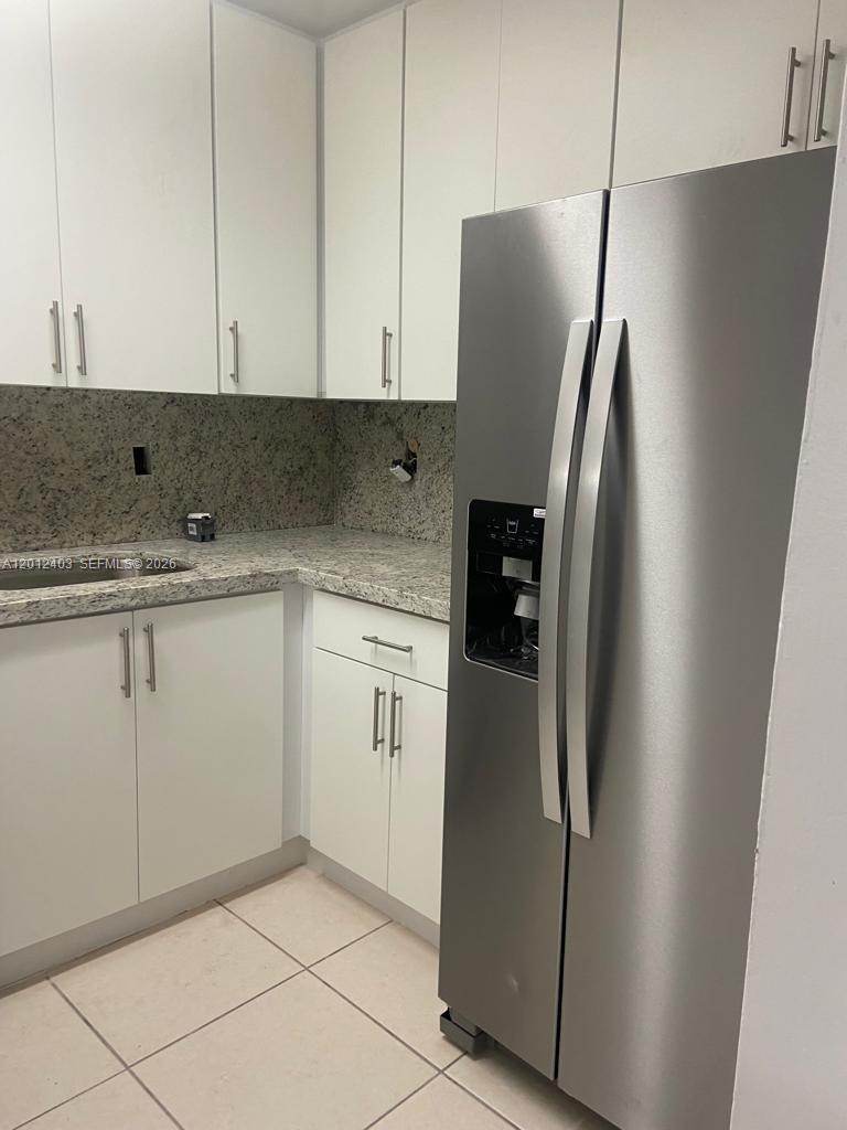 8990 Southwest 24th Street, Unit 19 Miami, FL 33165 - Photo 5 of 16 a kitchen with stainless steel appliances a refrigerator sink and cabinets