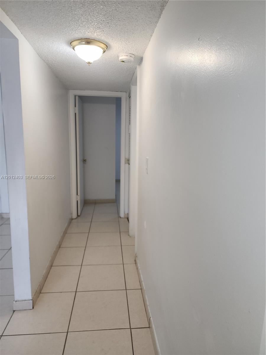 8990 Southwest 24th Street, Unit 19 Miami, FL 33165 - Photo 6 of 16 a view of livingroom with hallway