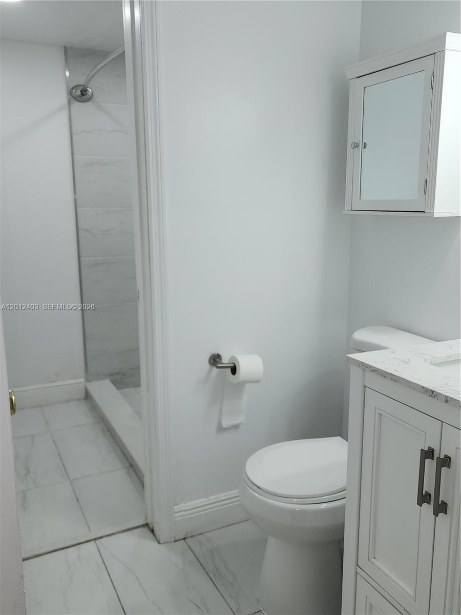 8990 Southwest 24th Street, Unit 19 Miami, FL 33165 - Photo 8 of 16 a bathroom with a toilet and a shower