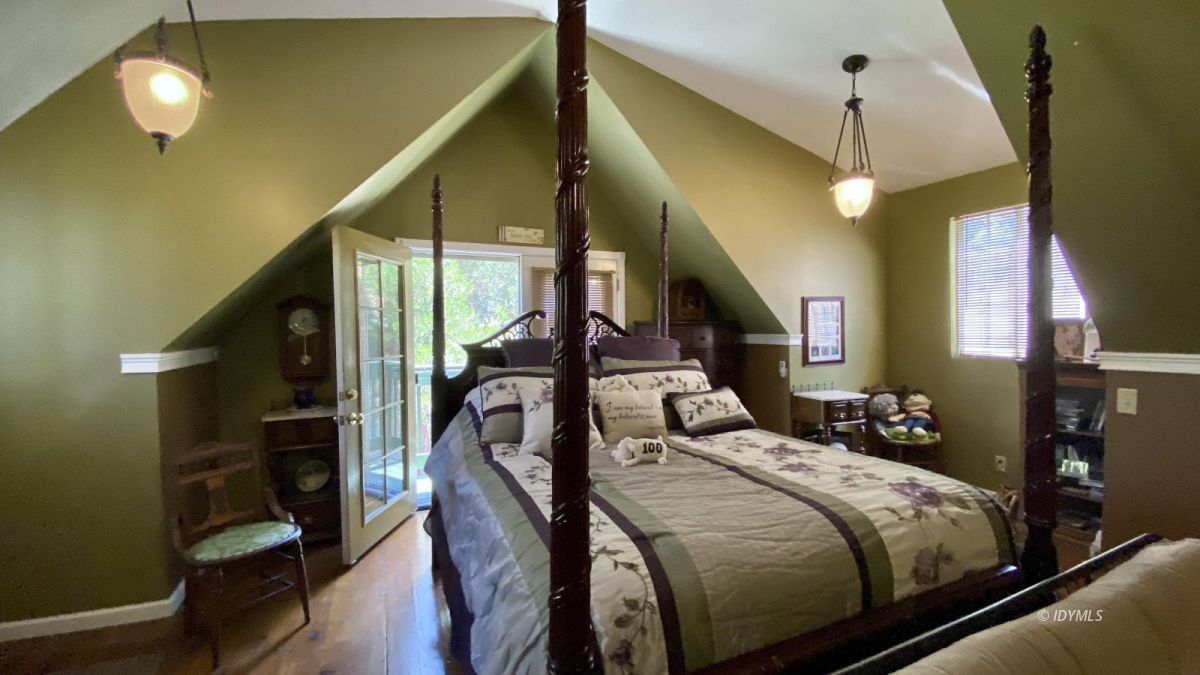 52905 Tollgate Road Idyllwild, CA 92549 - Photo 70 of 91 a bedroom with a bed and a chandelier