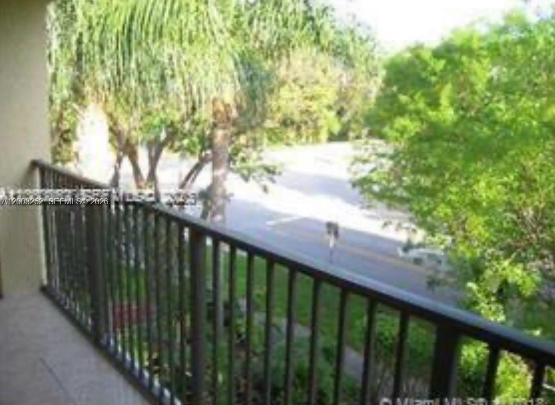 620 South Park Road, Unit 312 Hollywood, FL 33021 - Photo 4 of 14 a balcony with trees in front of it