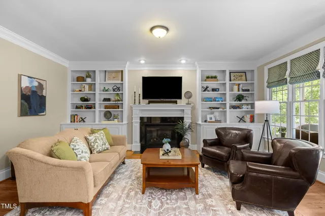 a view of a dining room with furniture a chandelier and wooden floor